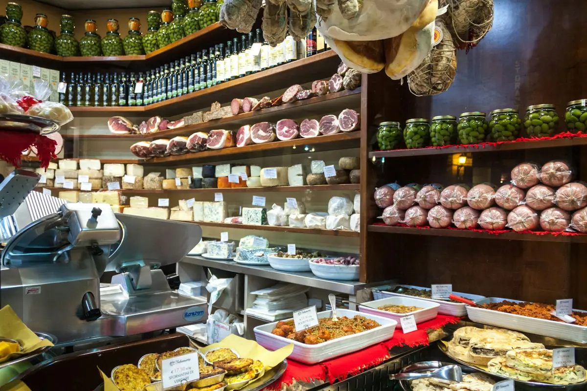 The deli counter, full of cheeses and cured meats