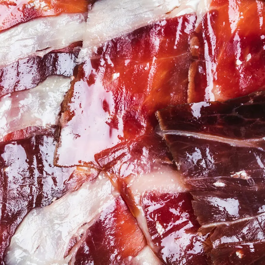 Thin hand-cut slices of acorn-fed ibérico ham, marbled with fat